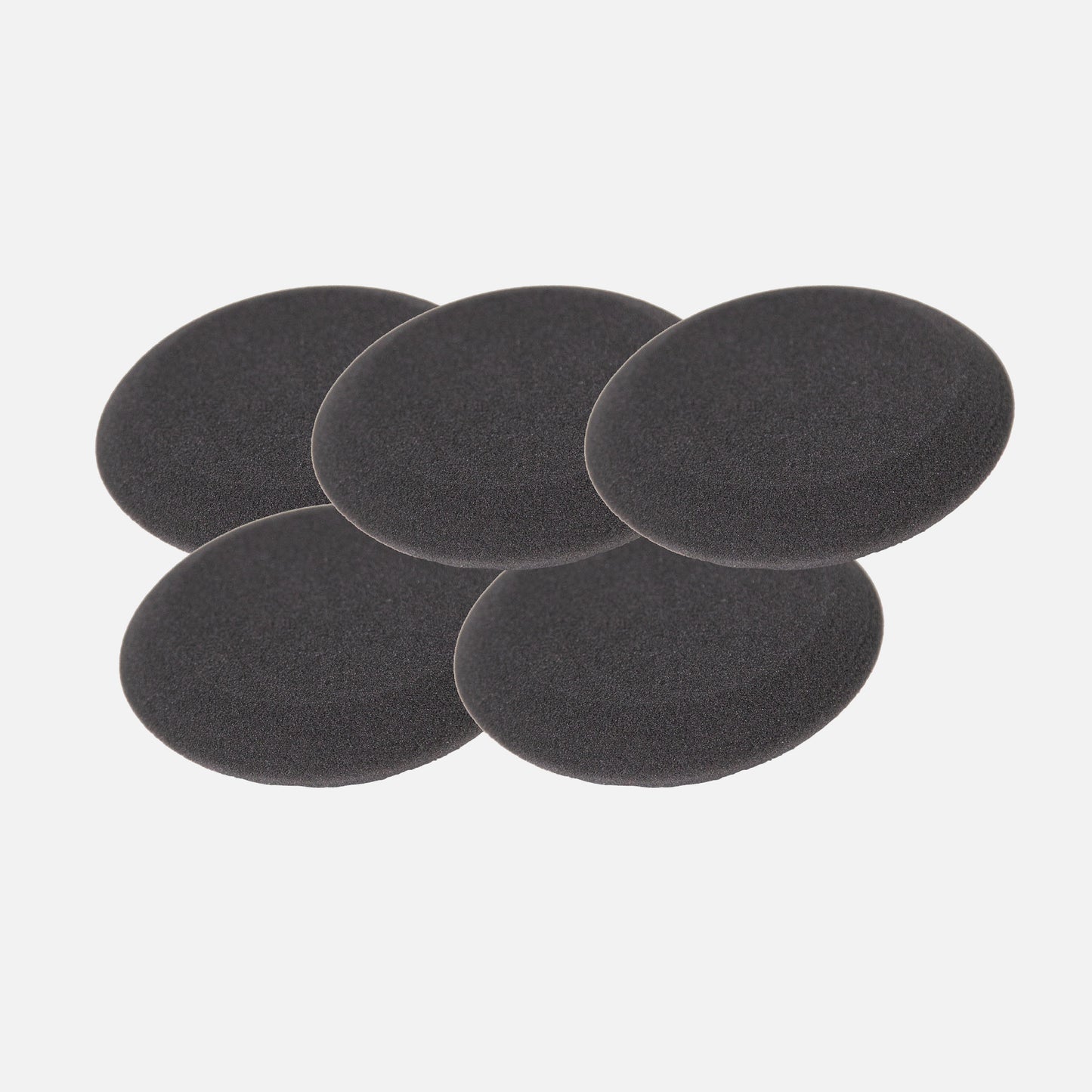 Five black, round, porous foam pads for car detailing are stacked on a white background.