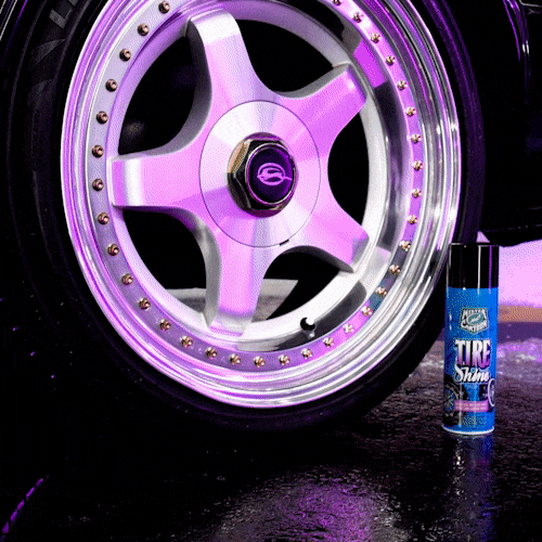 Clean, sleek car tire with a custom rim and a can of tire shine beside it.