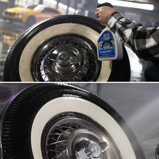 Auto detailer sprays tire cleaner on a classic car's white wall tire and chrome wheel. Car care maintenance on display.