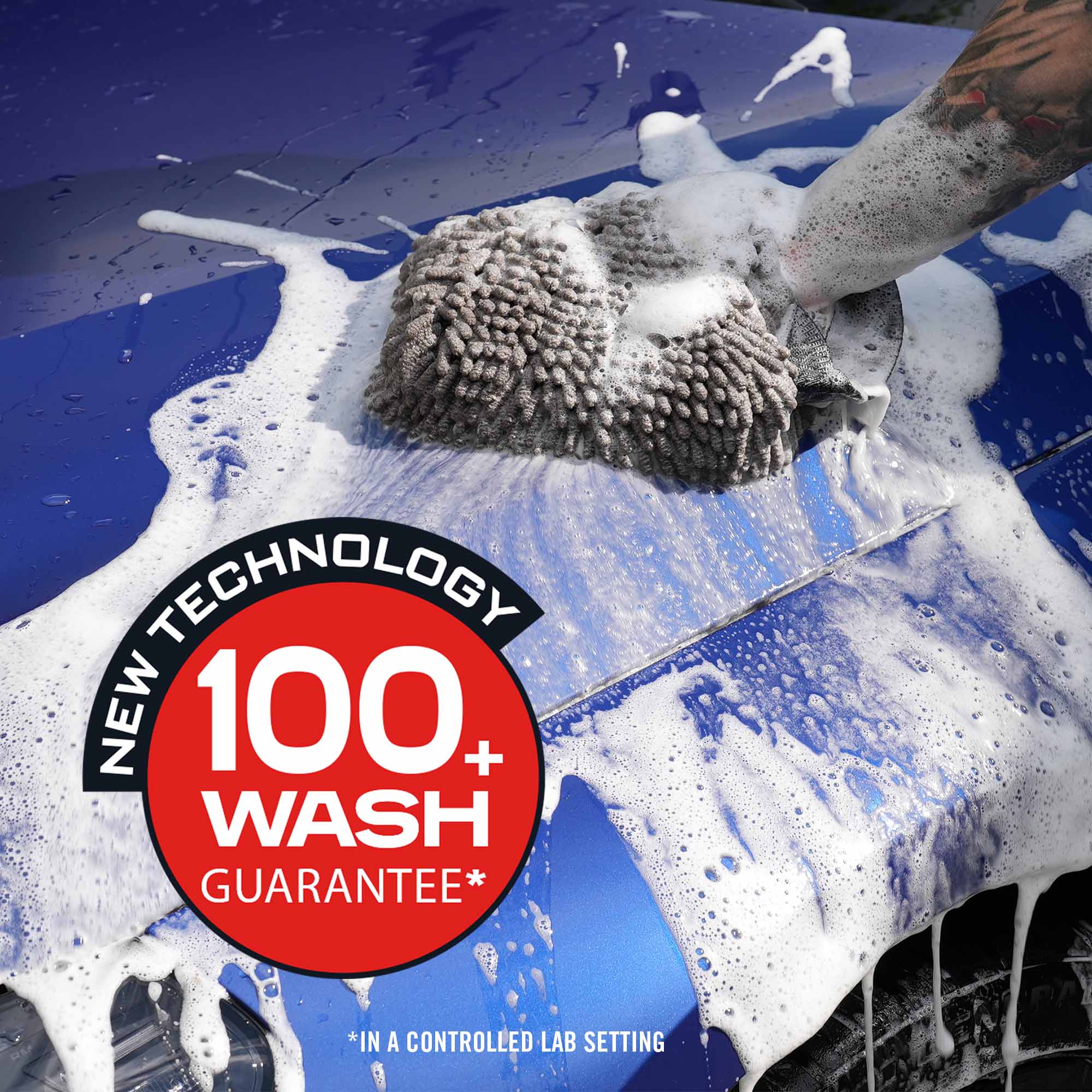 Car being washed with a sponge, featuring a 'New Technology 100+ Wash Guarantee' label.
