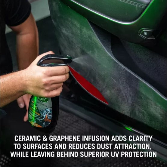 Turtle Wax sprays ceramic graphene car interior detailer on vehicle door panel. Protects & repels dust.