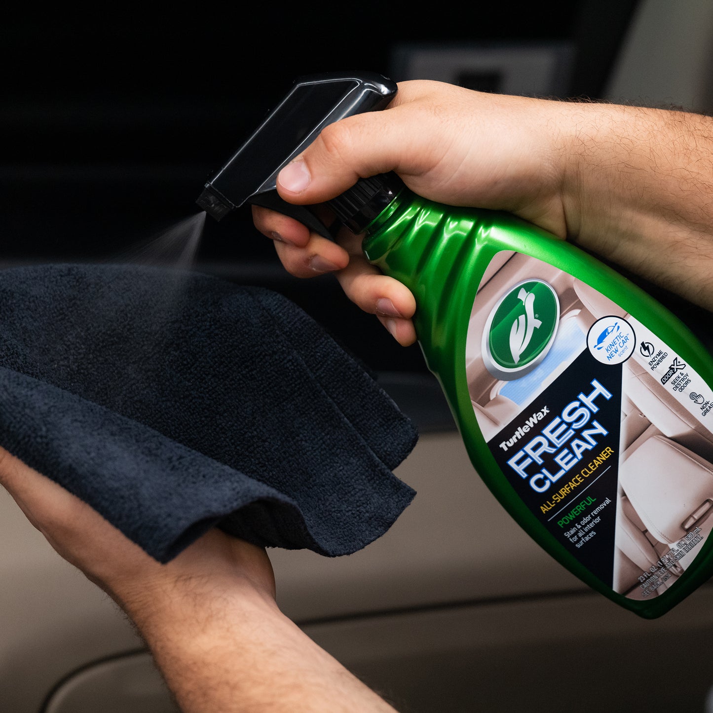 Turtle Wax Fresh Clean All-Surface Cleaner being sprayed onto a cloth. Great for stain and odor removal. Perfect for car interiors.