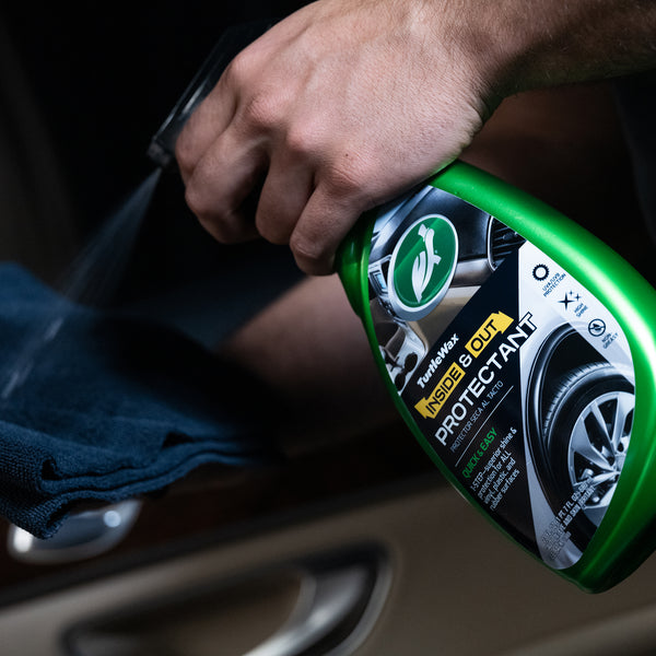 Close-up of protectant being sprayed on car's vinyl trim for restoration.