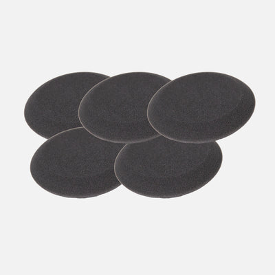 Five black, round, porous foam pads for car detailing are stacked on a white background.