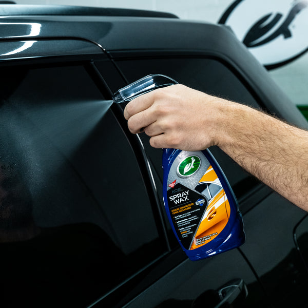Polishing a car panel with machine buffer, highlighting motion trails and buffing compound.