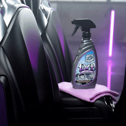 Turtle Wax LVP Interior Cleaner & Protectant bottle with trigger sprayer on microfiber cloth inside a car.
