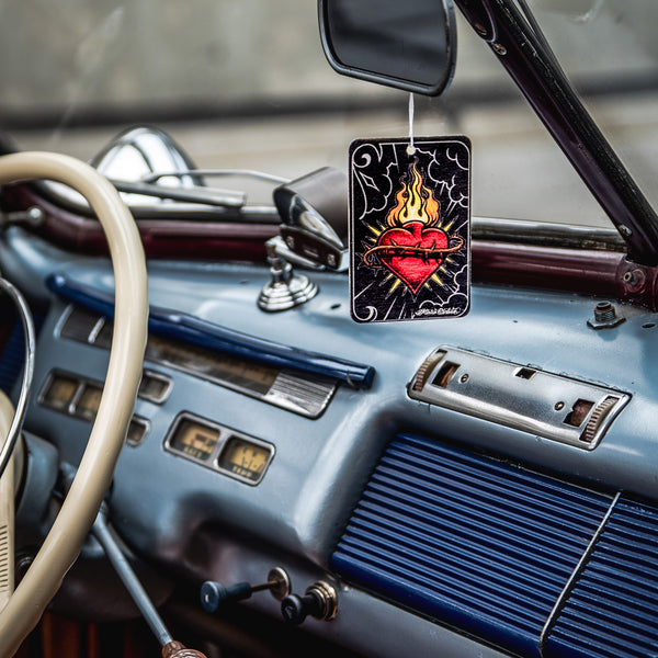 Product photo showing Sacred Soul air freshener paper held by a hand, giving a sense of its scale and portability.