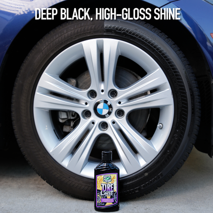 BMW tire with deep black shine. The car care product bottle is next to the wheel.