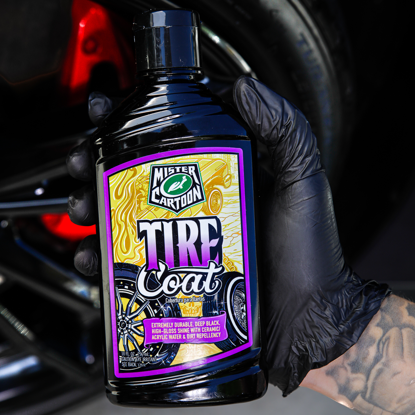 Mister Cartoon tire coat for car tires. Durable, deep black high-gloss shine, & dirt repellent. Detailer holding black bottle.
