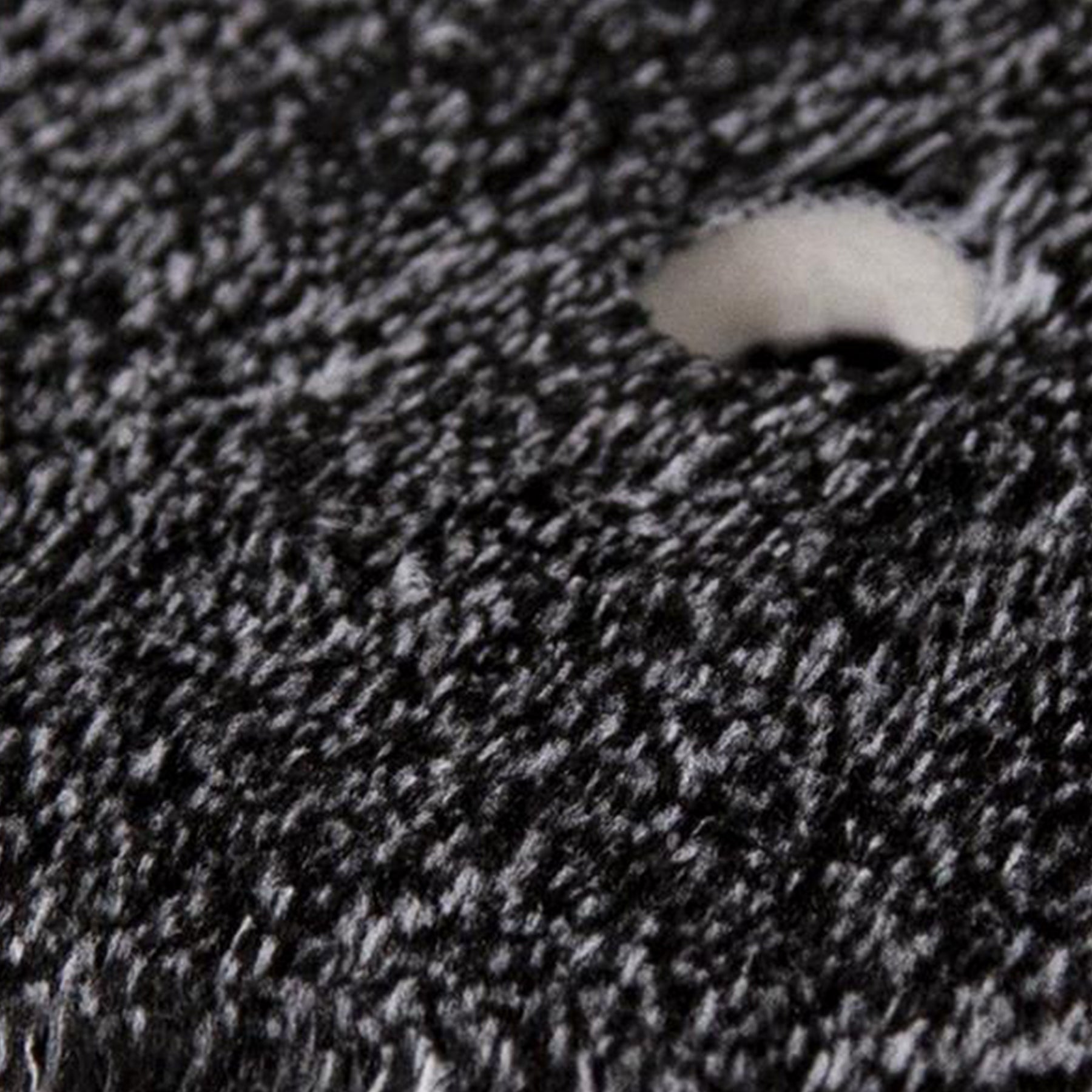 Close up of a 50/50 microfiber detailing pad. Dense black & white fibers. Excellent car care.