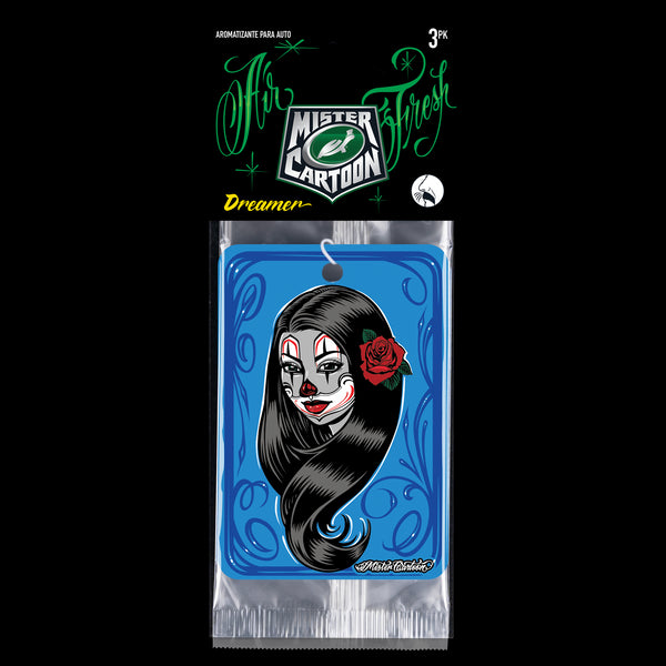 Shot of Mr. Cartoon Dreamer air freshener hanging inside a vintage car, partially reflecting in the windshield.