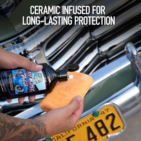 Close-up of car wax being applied in circular motions on a black hood with clear reflections.