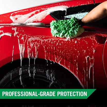 Red car being washed with a green wash mitt. Soapy water runs down the side.