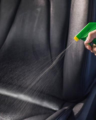 Leather cleaner sprayed onto car seats. Auto detailing for your vehicle's interior.