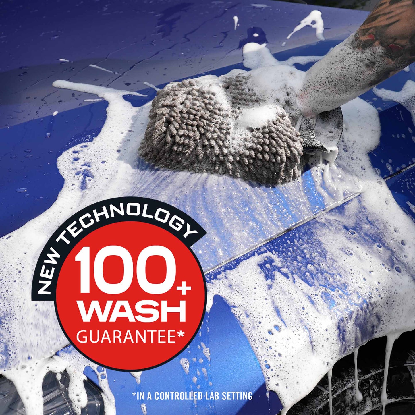 Car being washed with a sponge, featuring a 'New Technology 100+ Wash Guarantee' label.