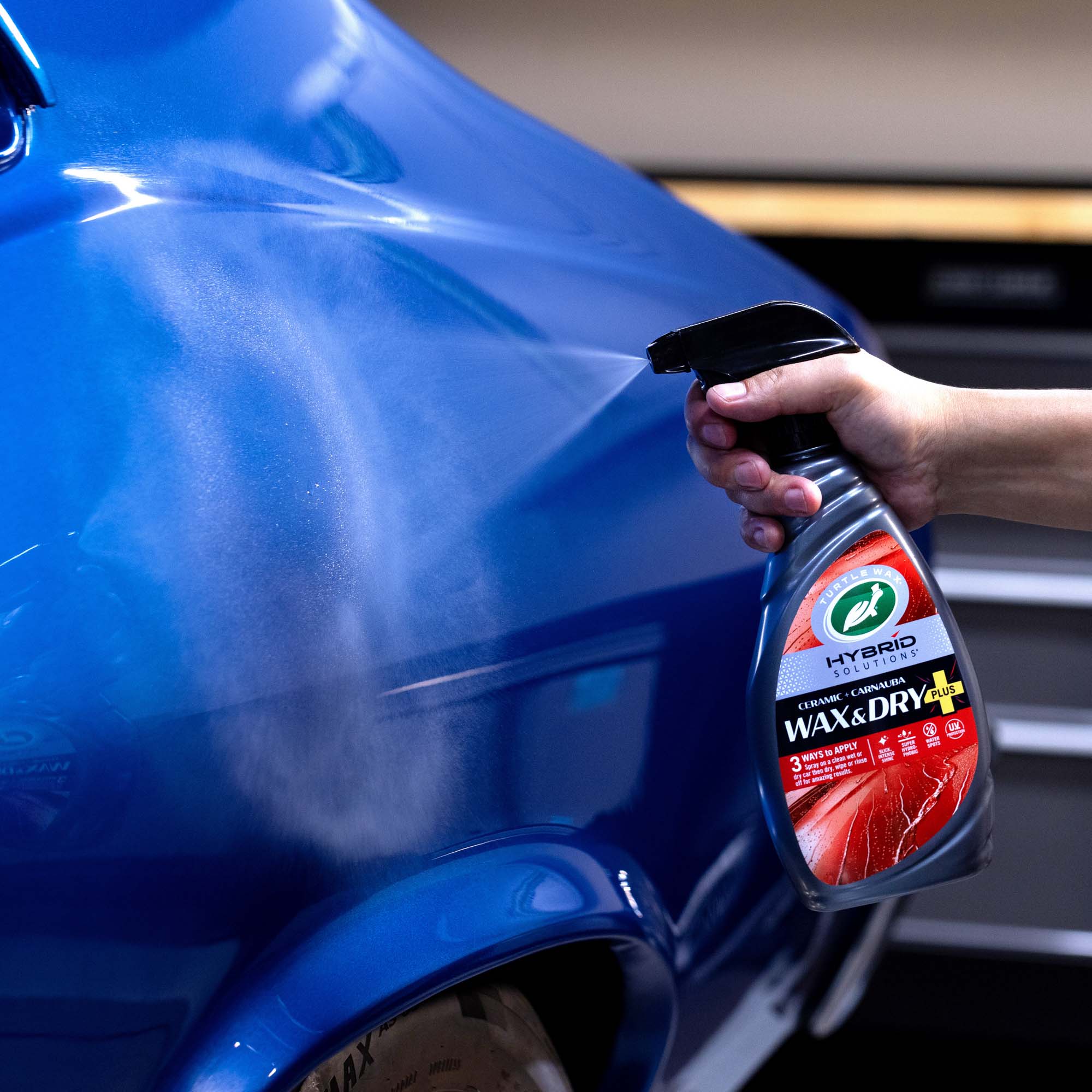 Man using the turtle wax wax and dry plus on a dry surface