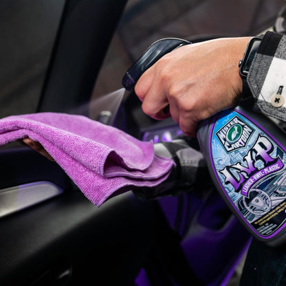 Detailer sprays Turtle Wax Mister Cartoon LVP cleaner. Microfiber towel cleans car interior.