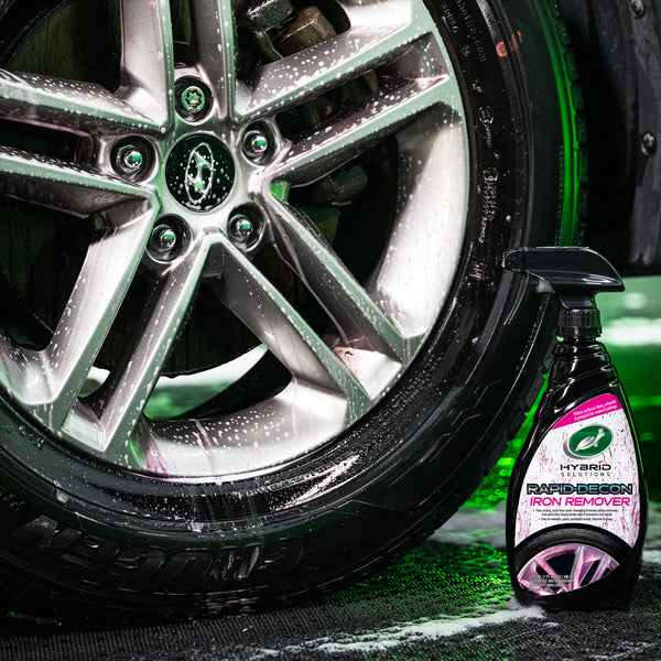 Application of spray wax to a glossy hood, with foam applicator and streak-free surface.