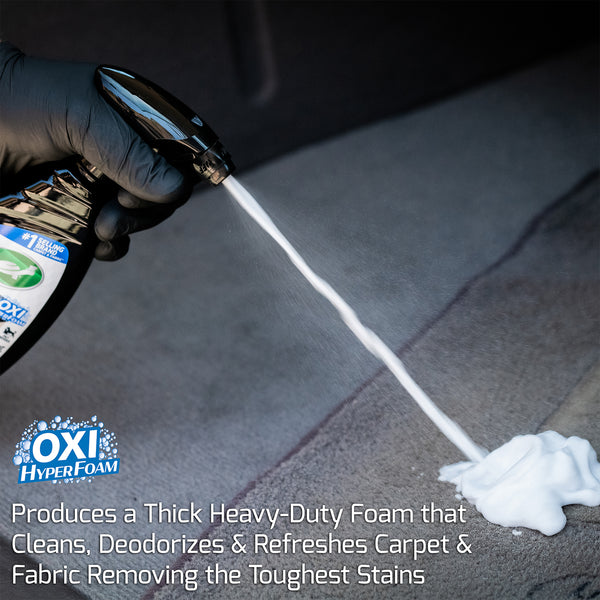 A hand sprays heavy foam from Spot Clean onto carpet. Text overlay reads "Produces a thick heavy foam that cleans, deodorizes and refreshes carpet"