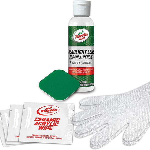 Spray bottle held in hand, aimed at carâ€™s exterior, demonstrating product usage.