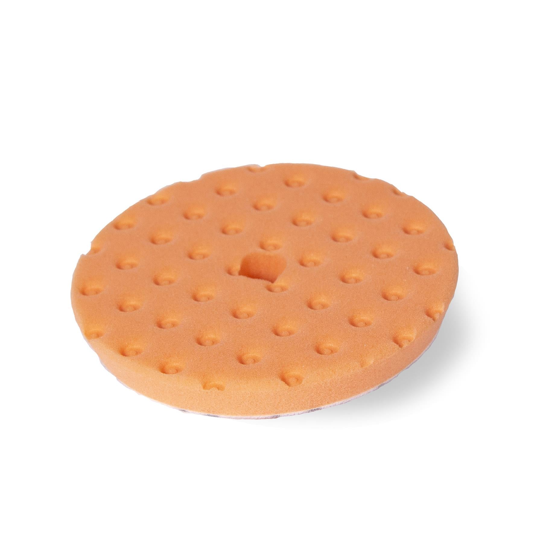 Round orange foam pad with CCS technology for auto paint correction.