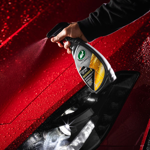 Angle view of Turtle Wax's Hybrid Solutions Ceramic Spray Coating bottle with orange fluid and clean product labeling.