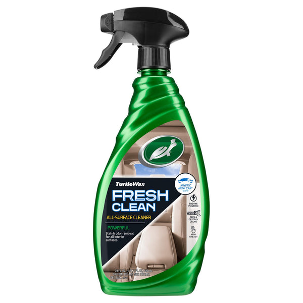 Fresh Clean product being used on vehicle interior surface, hand wiping dashboard.
